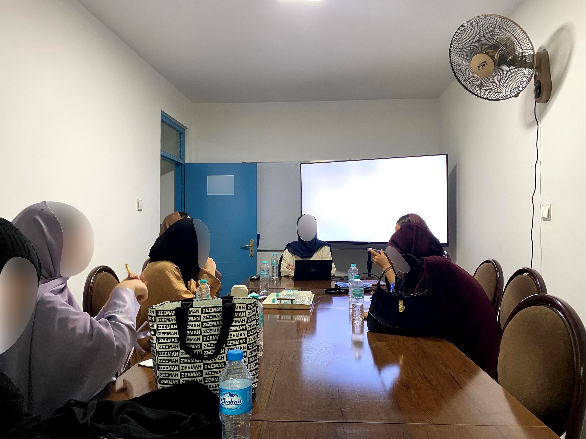 A seminar session, faces blurred